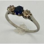 A diamond and sapphire three stone ring set in platinum