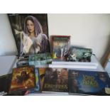 A collection of Lord of the rings items including figures, posters, jigsaw book etc