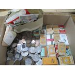 A collection of various coins, cigarette cards in boxes and loose stamps