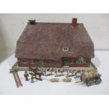 A wood and card dolls house, probably German circa 1930 with various wooden animals, hay cart and