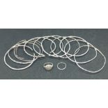 Six silver bangles, two silver rings and various other bangles
