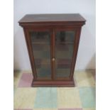 A small mahogany two door display cabinet