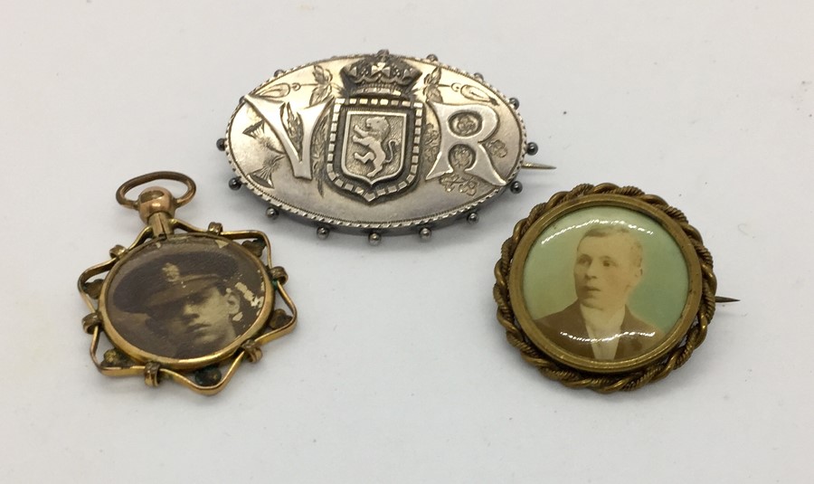 A Victorian hallmarked silver mourning brooch marked VR with the Swiss emblem along with a gold