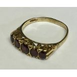 A garnet five stone ring set in 9ct gold