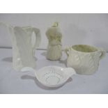 A Belleek jug along with two Royal Worcester items and a porcelain strainer