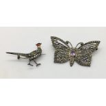 A silver butterfly brooch marked Luiber, set with an amethyst and marcasite along with a 935