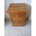 A pine bedside cabinet