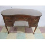 A kidney shaped desk/ dressing table on cabriole legs