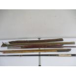 A collection of vintage fishing rods including Taylor & Johnson etc