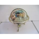 A gem set globe on gimbal base