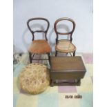 Two chairs along with a small drop leaf coffee table and a vintage pouffe