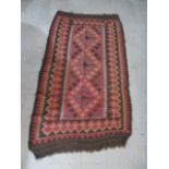 A small Kelim red ground rug