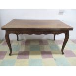 A French oak draw leaf table on cabriole legs