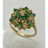 A 9ct gold emerald and diamond cluster ring.