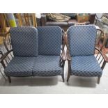 An Ercol dark wood two seater sofa and chairs