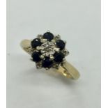 A 9ct gold diamond and sapphire cluster ring