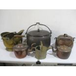 A copper cauldron along with various copper and brass items including kettles
