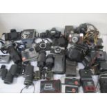 A collection of various cameras, lenses and binoculars, including Rollei, Canon, Pentax, Sony etc