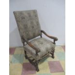 A Victorian upholstered armchair with carved frame and lion paw feet