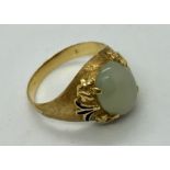 A gold ( hallmark badly rubbed) ring set with jade