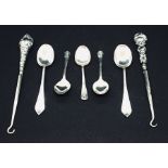 Five silver coffee spoons along with two silver handled button hooks