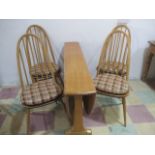 An Ercol dining table and four chairs
