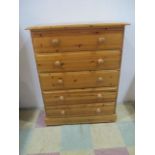 A pine chest of five drawers