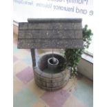 A concrete garden wishing well ornament A/F