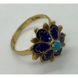 An 18ct gold ring set with central turquoise with enamel petals