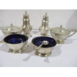 A hallmarked silver condiment set comprising of a pair of salts, pair of mustards and a pair of