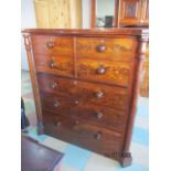 A Victorian flame mahogany serpentine fronted chest of three drawers with cupboard over