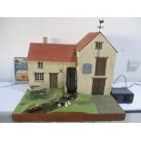 A complete working model of a water mill made by Brian Nickolls along with figures, handcart etc,