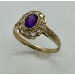 A 9ct gold diamond and amethyst cluster ring with diamond detail to shoulders.
