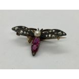 An unmarked gold Victorian brooch in the form of a fly, set with diamonds, rubies and seed pearl-
