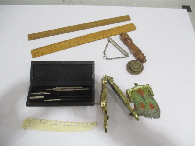 A collection of small items including whistle, chain purse, ivory letter opener, brass nut