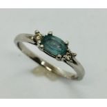 An 18 ct white gold ring aquamarine and diamond three stone ring