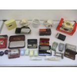 A collection of shaving equipment including safety razors, rolls razor, shaving mugs, electric