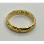 An 18ct gold wedding band. Weight 4.21g