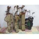 A collection of vintage and modern golf clubs including hickory shafted clubs