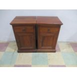 A pair of hardwood bedside cabinets