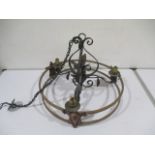 A wrought iron arts and crafts hanging lamp shade with brass and copper decoration