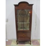 An Edwardian inlaid display cabinet with drop down music compartment
