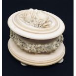 A 19th century ivory oval box carved with flowers, 1 foot A/F