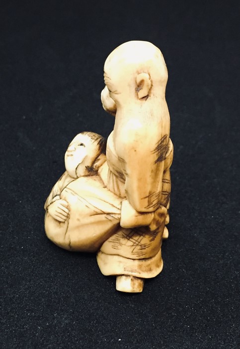 A 19th century carved Netsuke style figure of a bearded old man carrying a sack with a boy - Image 3 of 5