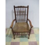 An oak framed chair with rattan seat