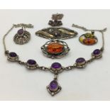 A collection of silver jewellery including necklaces and brooches