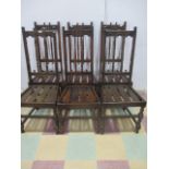 A set of six Ercol Gothic style oak dining chairs
