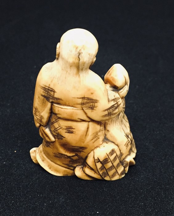 A 19th century carved Netsuke style figure of a bearded old man carrying a sack with a boy - Image 4 of 5