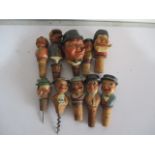 A collection of wooden bottle stoppers including Arni and a musical one - A/F, along with a