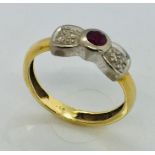 An 18ct gold ruby and illusion set diamonds in bow design, size N